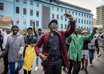 Protesters chant anti-government slogans during a demonstration against tax hikes as Members of the Parliament debate the Finance Bill 2024 in downtown Nairobi, on June 18, 2024. Kenyan police fired tear gas and arrested dozens of demonstrators on June 18, 2024 as hundreds of people gathered near the Parliament building to protest tax hikes. (Photo by LUIS TATO / AFP)