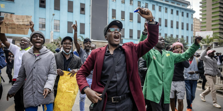 Protesters chant anti-government slogans during a demonstration against tax hikes as Members of the Parliament debate the Finance Bill 2024 in downtown Nairobi, on June 18, 2024. Kenyan police fired tear gas and arrested dozens of demonstrators on June 18, 2024 as hundreds of people gathered near the Parliament building to protest tax hikes. (Photo by LUIS TATO / AFP)