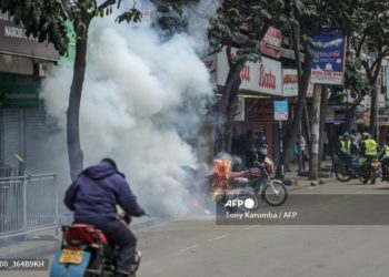 A tear gas canister explodes next to a scooter during renewed demonstrations in Nairobi on July 16, 2024. Police were out in force in the centre of Kenya's capital on Tuesday after calls for more demonstrations against the embattled government of President William Ruto. Activists led by young Gen-Z Kenyans launched peaceful rallies a month ago against deeply unpopular tax hikes but they descended into deadly violence last month, prompting Ruto to drop the planned increases. (Photo by Tony Karumba / AFP)