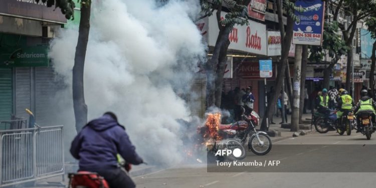 A tear gas canister explodes next to a scooter during renewed demonstrations in Nairobi on July 16, 2024. Police were out in force in the centre of Kenya's capital on Tuesday after calls for more demonstrations against the embattled government of President William Ruto. Activists led by young Gen-Z Kenyans launched peaceful rallies a month ago against deeply unpopular tax hikes but they descended into deadly violence last month, prompting Ruto to drop the planned increases. (Photo by Tony Karumba / AFP)