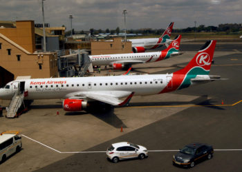 Kenya Airways planes are seen through a window as the Jomo Kenyatta international airport reopens after flights were suspended following the coronavirus disease (COVID-19) outbreak in Nairobi, Kenya August 1, 2020. REUTERS/Njeri Mwangi//File Photo