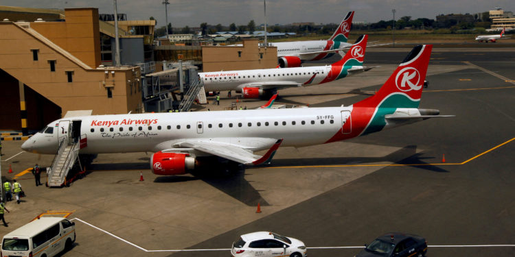 Kenya Airways planes are seen through a window as the Jomo Kenyatta international airport reopens after flights were suspended following the coronavirus disease (COVID-19) outbreak in Nairobi, Kenya August 1, 2020. REUTERS/Njeri Mwangi//File Photo