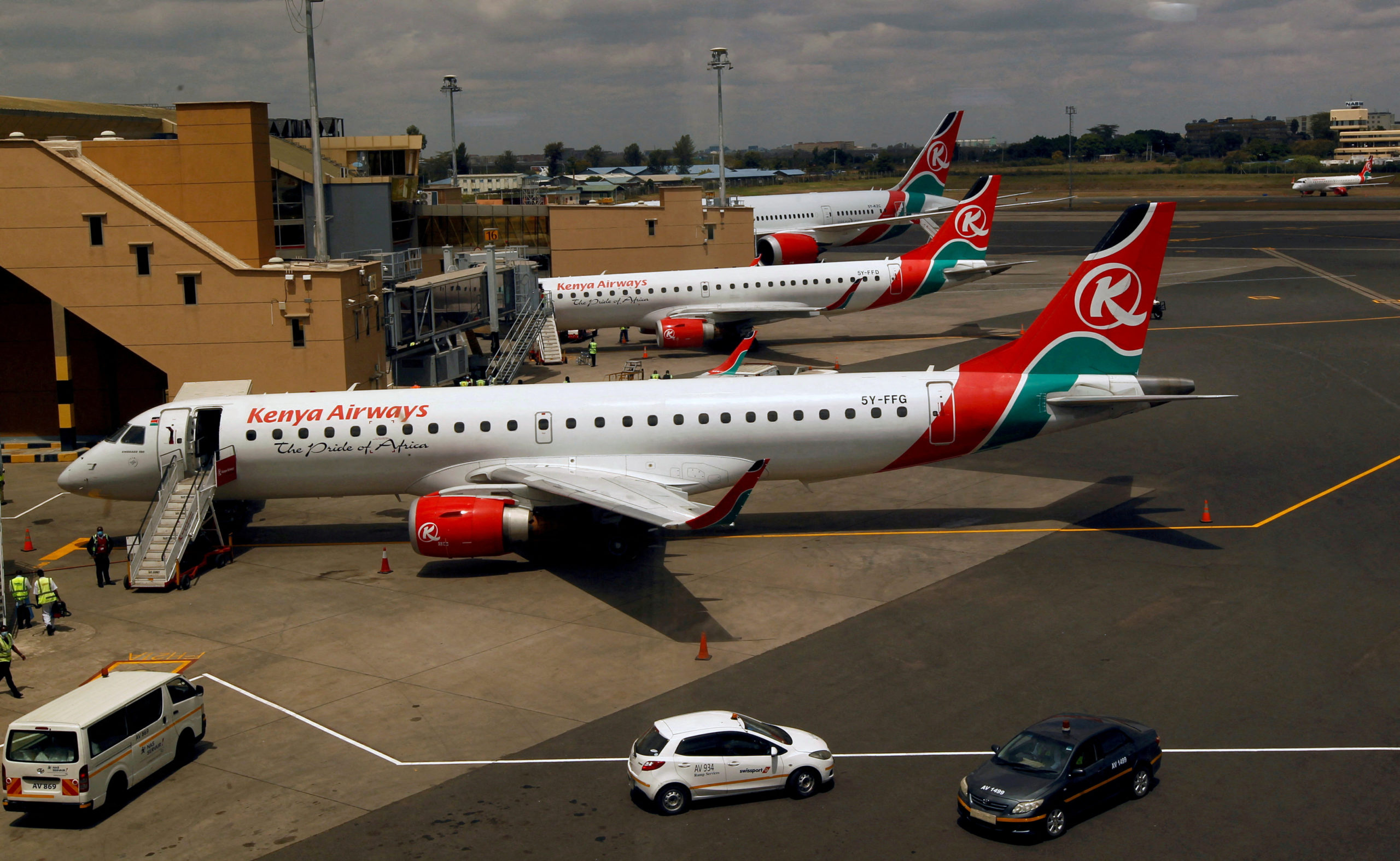 Kenya Airways planes are seen through a window as the Jomo Kenyatta international airport reopens after flights were suspended following the coronavirus disease (COVID-19) outbreak in Nairobi, Kenya August 1, 2020. REUTERS/Njeri Mwangi//File Photo