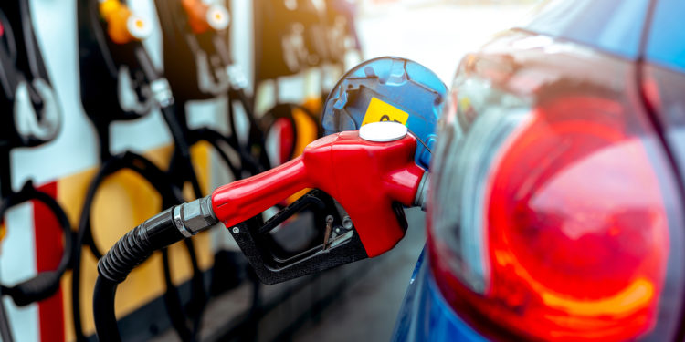 Car fueling at gas station. Refuel fill up with petrol gasoline. Petrol pump filling fuel nozzle in fuel tank of car at gas station. Petrol industry and service. Petrol price and oil crisis concept.