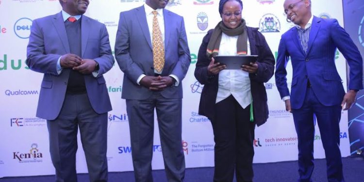 From left, Principal Secretary Ministry of ICT Jerome Ochieng, Cabinet Secretary Ministry of Labour & Youth Affairs, Simon Chelugui and Safaricom PLC CEO Peter Ndegwa look on as Sylvia Wangari takes them through a digital concept. This was during the launch of the Industry Digital talent programme at the Safaricom offices.