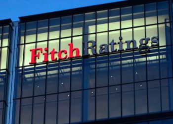 A sign for the financial agency Fitch Ratings Ltd., located within 30 North Colonnade, is seen on a building at the Canary Wharf business and shopping district in London, U.K., on Thursday, March 1, 2012. Moody?s Investors Service said Feb. 14 that Britain may lose its Aaa credit rating. Photographer: Matt Lloyd/Bloomberg via Getty Image