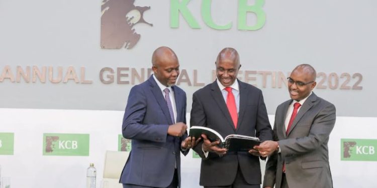 From Left: KCB Group Chief Financial Officer, Lawrence Kimathi, Group Chairman Andrew Wambari Kairu and Group CEO Mr. Paul Russo peruse through the 2021 Integrated Report during the bank's 51st Annual General Meeting conducted virtually. During the meeting, shareholders approved KShs. 9.64 billion total dividends pay-out for the 2021 financial year.