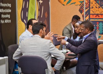 Shelter Afrique Ag. CEO & Chief Finance Officer Mr. Kingsley Muwowo (right) explaining engaging with delegates at the 11th World Urban Forum held in the Polish city of Katowice.