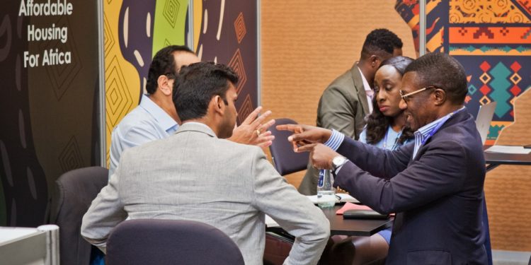 Shelter Afrique Ag. CEO & Chief Finance Officer Mr. Kingsley Muwowo (right) explaining engaging with delegates at the 11th World Urban Forum held in the Polish city of Katowice.