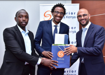 Superior Homes Kenya CEO Shiv Arora (R) presents a gift hamper to home buyers Cornelius Kimano (C) and Elvis Wakaba (L) during the launch of Lukenya Wildlife Estate, a 100-acre luxury project within Swara Plains Conservancy in Machakos County that will comprise of high-end residential houses and serviced plots.