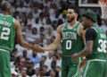 Boston Celtics forward Jayson Tatum (0) and center Al Horford (42) congratulate each other during a break in the second half of Game 4 during the NBA basketball playoffs Eastern Conference finals against the Miami Heat, Tuesday, May 23, 2023, in Miami. (AP Photo/Wilfredo Lee)