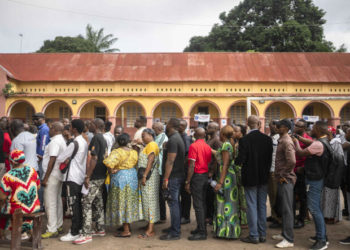 Voters queue outside a polling station during the presidential elections in Kinshasa, Democratic Republic of Congo, Wednesday, Dec. 20, 2023. Congo headed to the polls Wednesday to vote for president as authorities scrambled to finalise preparations in an election facing steep logistical and security challenges. (AP Photo/Mosa'ab Elshamy)