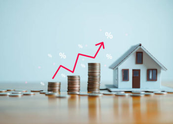 The up arrow shows the inflation rate. Interest rates increase, home loan, mortgage, house tax. investment and asset management concept. percentage for increasing interest rates with stacks coins