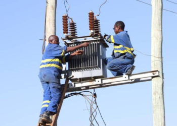 Kenya power technicians install a transformer at Ibutuka Village in Mbeere North in Embu County (Murithi Mugo, Standard)