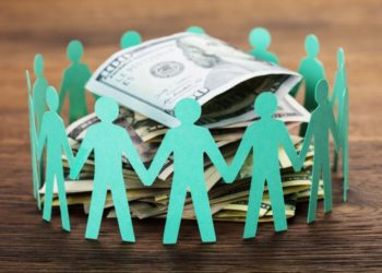 Crowdfunding Concept. Paper Cut Out Human Figures Around The Stack Of Hundred Dollar Bills